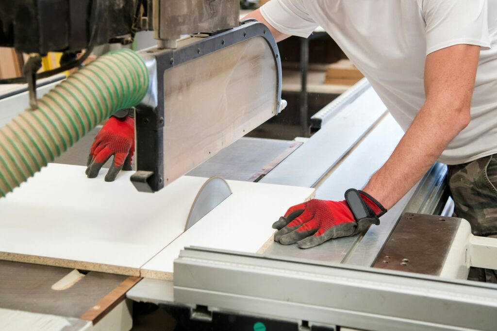Carpenter or joiner cutting a wooden board